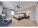 King-size bed, nightstands, ceiling fan, and comfortable armchair at 4722 Sleepy Hollow Dr, Kissimmee, FL 34746