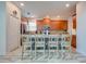 Open concept kitchen with island seating and wood cabinets at 4722 Sleepy Hollow Dr, Kissimmee, FL 34746