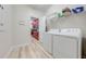 Laundry room with washer, dryer, and access to the kitchen at 4722 Sleepy Hollow Dr, Kissimmee, FL 34746