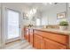 Double vanity bathroom with granite countertop and access to backyard at 4722 Sleepy Hollow Dr, Kissimmee, FL 34746