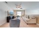 Bright Gathering room with large TV, comfortable seating, and ceiling fan at 4722 Sleepy Hollow Dr, Kissimmee, FL 34746