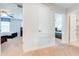 View down a hallway featuring carpet, a door, and glimpses into bedrooms at 4722 Sleepy Hollow Dr, Kissimmee, FL 34746