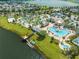 Aerial view of community with resort-style pool, water features, and lake at 4722 Sleepy Hollow Dr, Kissimmee, FL 34746