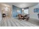 Bright dining room with a wooden table and chairs, and access to the foyer at 4722 Sleepy Hollow Dr, Kissimmee, FL 34746