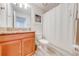 Clean bathroom with granite countertop, wood cabinets, and shower at 4722 Sleepy Hollow Dr, Kissimmee, FL 34746