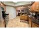 Modern kitchen with wooden cabinets, granite countertops, and stainless steel appliances at 5300 S Atlantic Ave # 19-306, New Smyrna Beach, FL 32169