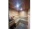 Relaxing sauna with wooden benches and bucket at 5300 S Atlantic Ave # 19-306, New Smyrna Beach, FL 32169