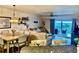 Open living space with dining area, comfortable seating, and access to a balcony at 5300 S Atlantic Ave # 19-306, New Smyrna Beach, FL 32169