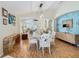 Open dining area with light walls, wood flooring and a view into the living room at 205 Bell Tower W Xing, Kissimmee, FL 34759