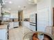 Spacious kitchen with white cabinets and breakfast nook at 205 Bell Tower W Xing, Kissimmee, FL 34759