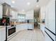 Open concept kitchen with white cabinets and tile flooring at 205 Bell Tower W Xing, Kissimmee, FL 34759