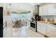 Bright kitchen with white cabinets, butcher block counters, and breakfast area at 205 Bell Tower W Xing, Kissimmee, FL 34759