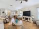Bright living room with hardwood floors, comfortable seating, and a large TV at 205 Bell Tower W Xing, Kissimmee, FL 34759