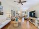Bright living room with hardwood floors, comfortable seating, and a view of the dining area at 205 Bell Tower W Xing, Kissimmee, FL 34759