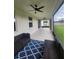 Relaxing screened porch with blue rug and wicker furniture at 3866 Cabo Rojo Dr, Saint Cloud, FL 34772