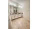Elegant bathroom with double vanity, granite countertops, and tiled flooring at 1837 Hickory Bluff Rd, Kissimmee, FL 34744