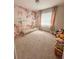 Adorable bedroom with teepee bed and floral wall mural at 1837 Hickory Bluff Rd, Kissimmee, FL 34744