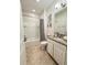 Clean bathroom with a bathtub, shower, and granite countertop at 1837 Hickory Bluff Rd, Kissimmee, FL 34744