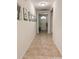 Long hallway with tile flooring and neutral wall decor at 1837 Hickory Bluff Rd, Kissimmee, FL 34744