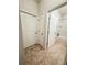 Hallway with neutral tile flooring and access to the bathroom at 1837 Hickory Bluff Rd, Kissimmee, FL 34744