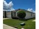 Single-story house with a two-car garage and well-maintained lawn at 1837 Hickory Bluff Rd, Kissimmee, FL 34744