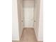 Bright hallway with neutral-colored carpet and two doors at 1837 Hickory Bluff Rd, Kissimmee, FL 34744