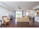 Open living space with hardwood floors, floral sofa, and view into dining area and kitchen at 4177 N Orange Blossom Trl # 210, Orlando, FL 32804