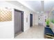 Building lobby with two elevators and an exit at 4177 N Orange Blossom Trl # 210, Orlando, FL 32804