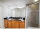 Bathroom with double vanity, granite countertop, and shower at 4177 N Orange Blossom Trl # 210, Orlando, FL 32804