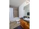 Clean bathroom with tub shower, granite vanity, and dark wood cabinets at 4177 N Orange Blossom Trl # 210, Orlando, FL 32804