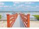 Wooden dock with orange railings leading to the lake at 4177 N Orange Blossom Trl # 210, Orlando, FL 32804