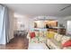 Open living room with floral couch, hardwood floors, and kitchen view at 4177 N Orange Blossom Trl # 210, Orlando, FL 32804