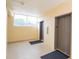 Building lobby with elevators and a seating area for residents at 4177 N Orange Blossom Trl # 210, Orlando, FL 32804