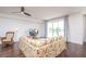Bright living room with hardwood floors, floral sofa, and sliding glass doors to balcony at 4177 N Orange Blossom Trl # 210, Orlando, FL 32804