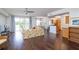 Spacious living area with hardwood floors, sofa, and access to balcony and kitchen at 4177 N Orange Blossom Trl # 210, Orlando, FL 32804