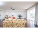 Living room with floral sofa and sliding glass doors to balcony at 4177 N Orange Blossom Trl # 210, Orlando, FL 32804