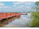 Wooden dock with orange railings and a boat at 4177 N Orange Blossom Trl # 210, Orlando, FL 32804