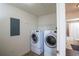 Laundry room with washer, dryer, and shelving at 4177 N Orange Blossom Trl # 210, Orlando, FL 32804