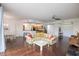 Open living room with floral couch, hardwood floors, and kitchen view at 4177 N Orange Blossom Trl # 210, Orlando, FL 32804