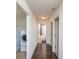Hallway with dark wood floors, leading to laundry and bathroom at 4177 N Orange Blossom Trl # 210, Orlando, FL 32804