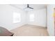 Bright bedroom with two windows, neutral walls, and carpeted floors at 4177 N Orange Blossom Trl # 210, Orlando, FL 32804