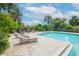 Community pool with lounge chairs and a grilling area at 4177 N Orange Blossom Trl # 210, Orlando, FL 32804