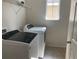 Laundry room with washer, dryer, and shelving at 10710 Reams Rd, Windermere, FL 34786