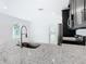 Kitchen features granite countertops and a modern farmhouse sink at 623 Sylvan Ramble Rd, Davenport, FL 33837