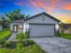 Modern single-story home with a two-car garage at 623 Sylvan Ramble Rd, Davenport, FL 33837