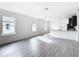 Open living room with gray vinyl plank flooring and kitchen view at 623 Sylvan Ramble Rd, Davenport, FL 33837