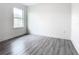 Simple bedroom with grey vinyl flooring and a window at 623 Sylvan Ramble Rd, Davenport, FL 33837
