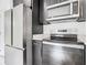 Stainless steel appliances and dark cabinetry in modern kitchen at 623 Sylvan Ramble Rd, Davenport, FL 33837