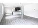 Spacious living room with gray vinyl plank flooring and lots of natural light at 623 Sylvan Ramble Rd, Davenport, FL 33837