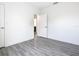 Simple bedroom with wood-look floors and access to bathroom at 623 Sylvan Ramble Rd, Davenport, FL 33837